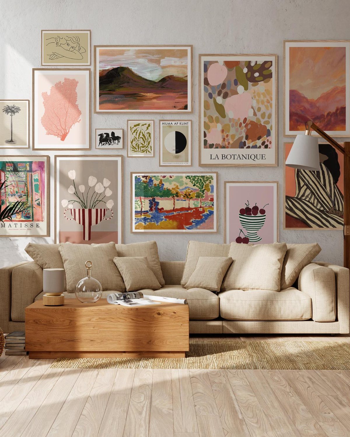 Gallery wall with various framed art prints above a beige living room sofa