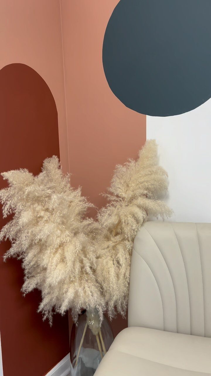 Terracotta wall with a dark red painted arch and a grey circle decoration.
