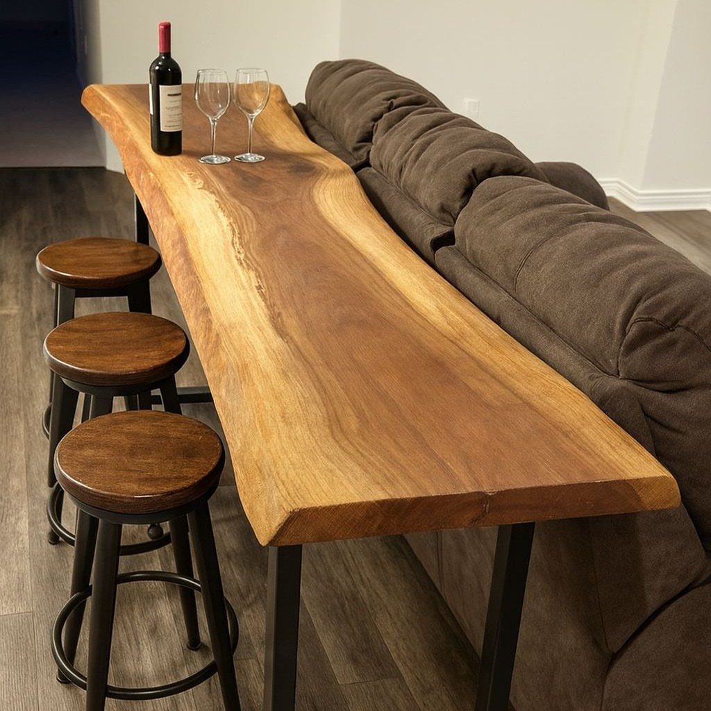 Live-edge wooden bar table with stools placed behind a brown fabric couch