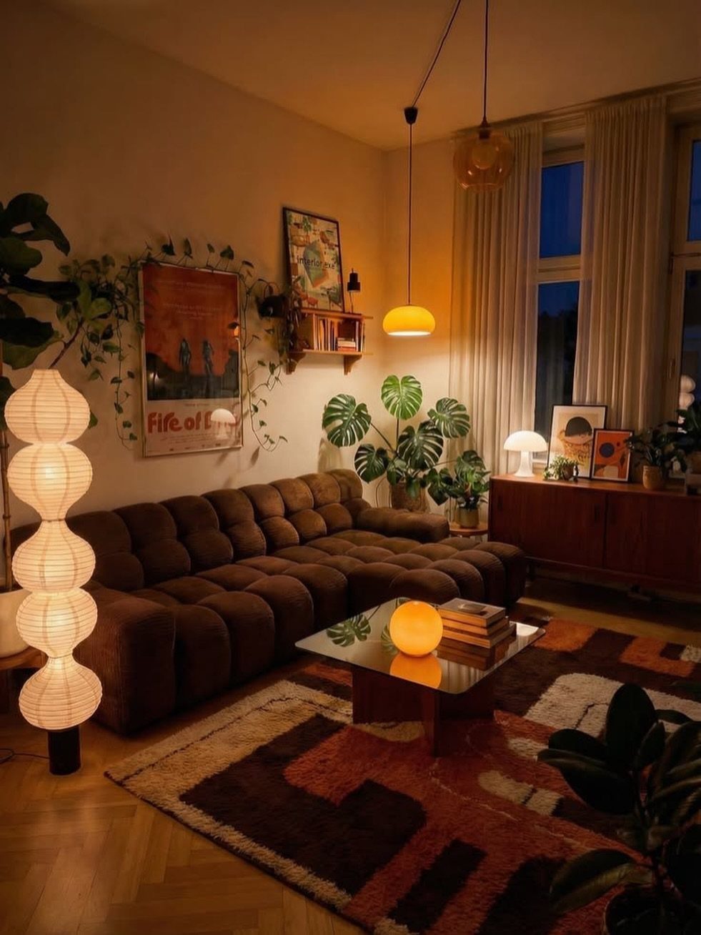 Dark brown modular sofa in a warm living room with patterned rugs and lamps.