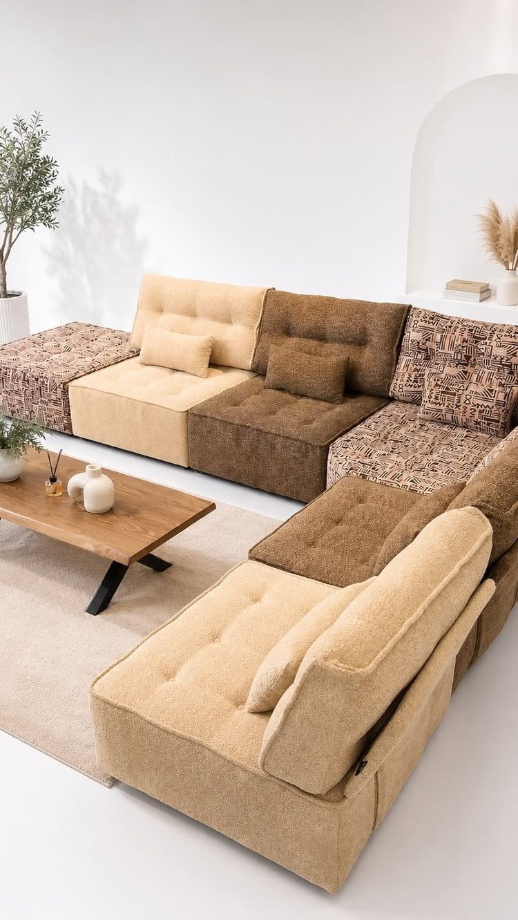 Modular brown and tan sectional sofa with patterned fabric sections in a bright room.