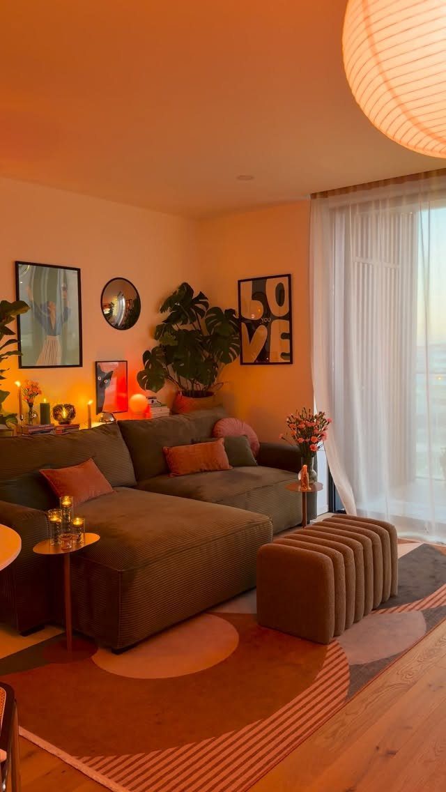 Brown sectional sofa with orange pillows in a warm living room with geometric rug