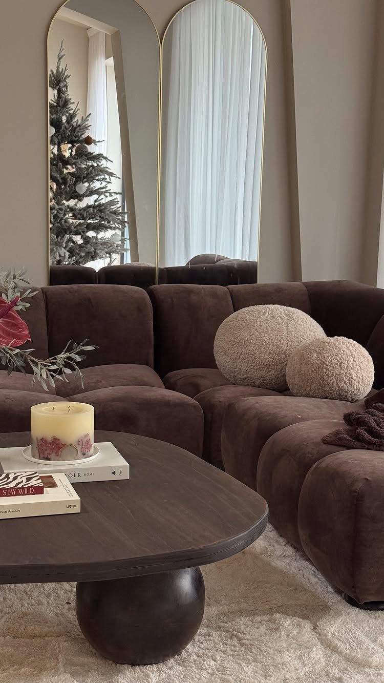 Brown modular sofa with round pillows and dark coffee table in a living room