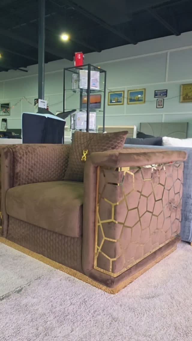 Brown velvet armchair featuring a gold metallic honeycomb pattern on the side arm.