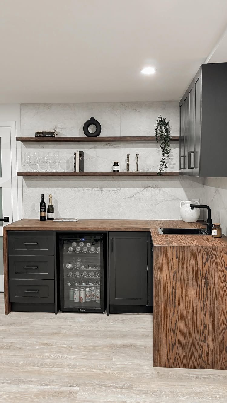 Built-in wet bar with dark cabinets, wooden counters, and a beverage cooler.