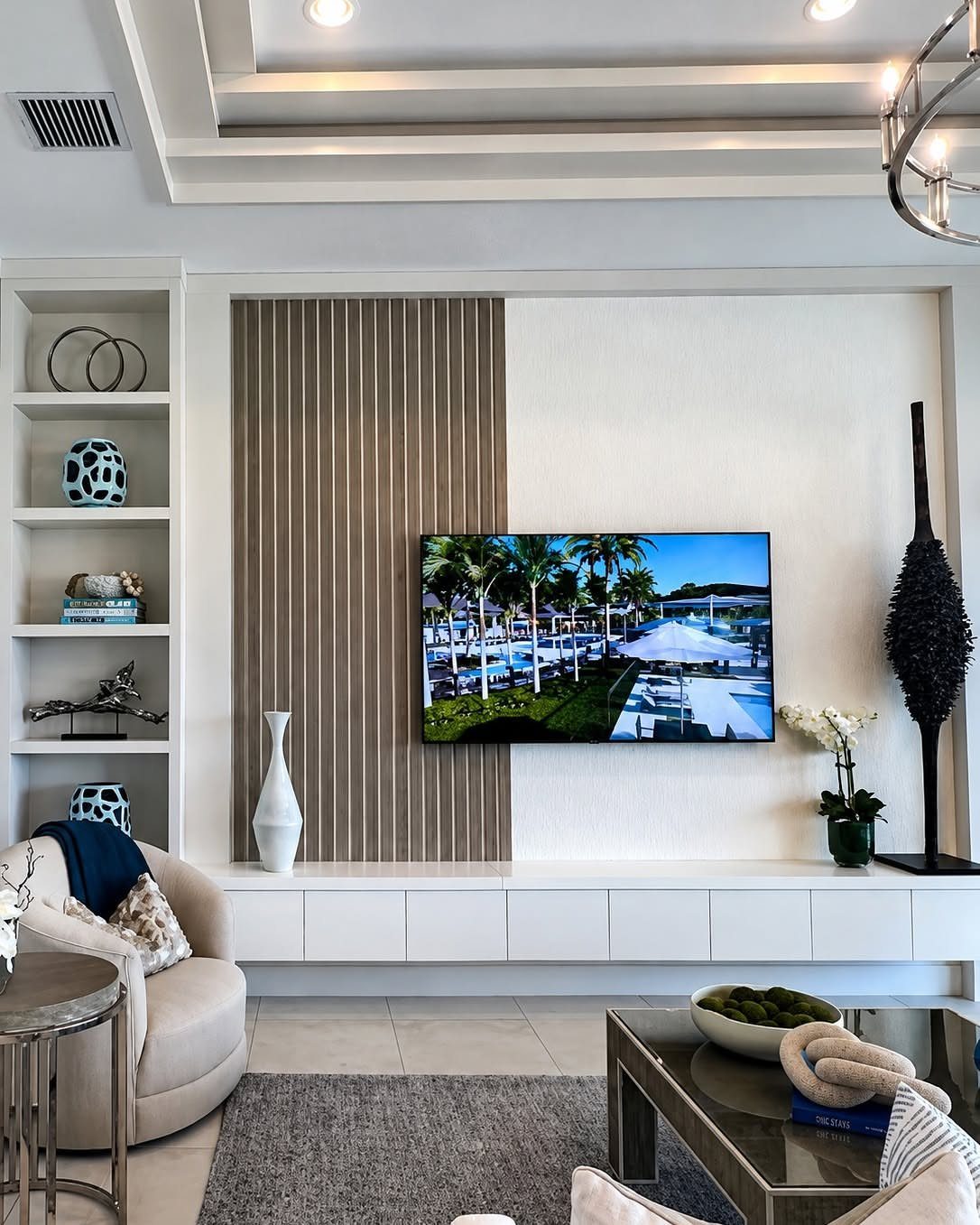 White built-in unit with open shelving and low cabinets in a modern living room
