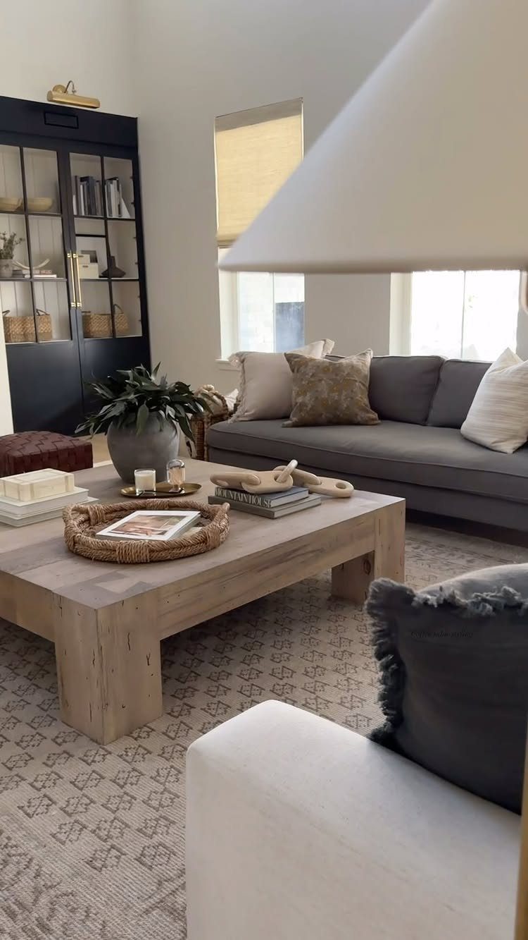 Light wood coffee table with decor in a contemporary farmhouse living room