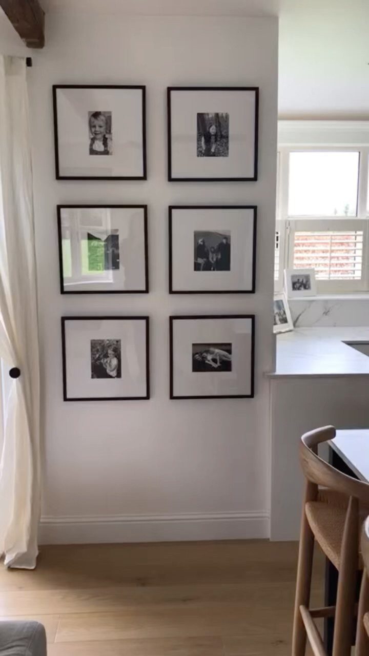 Six black-framed black and white photographs arranged in a grid on a white wall.