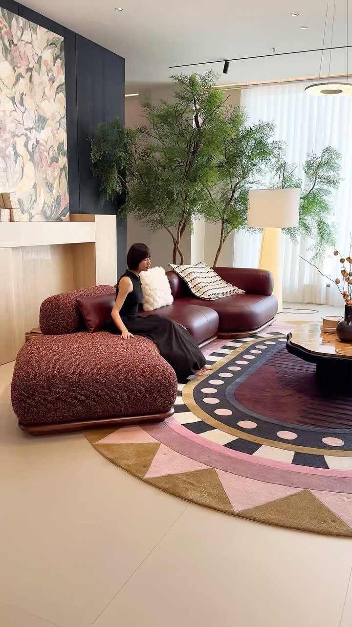 Curved burgundy modular sofa as a focal point in a contemporary living room