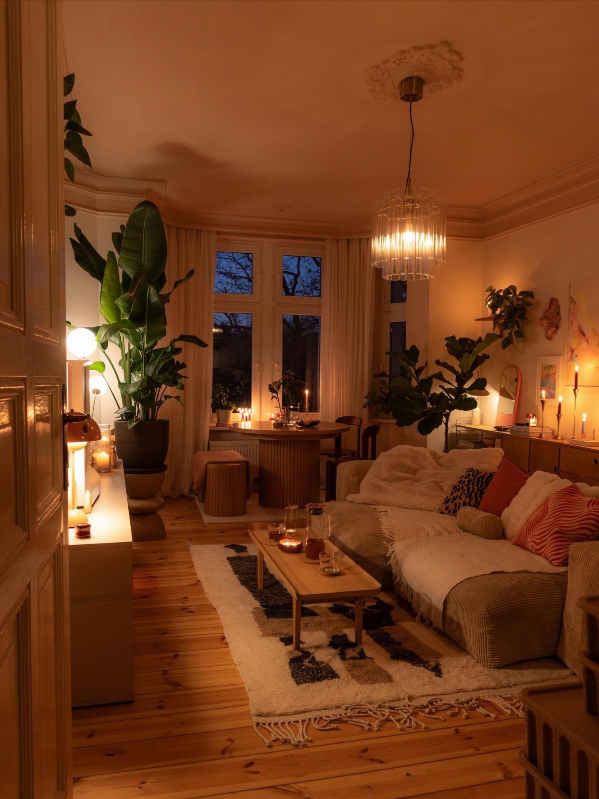 Cozy living room with a sofa and rug separating the lounge from dining area.