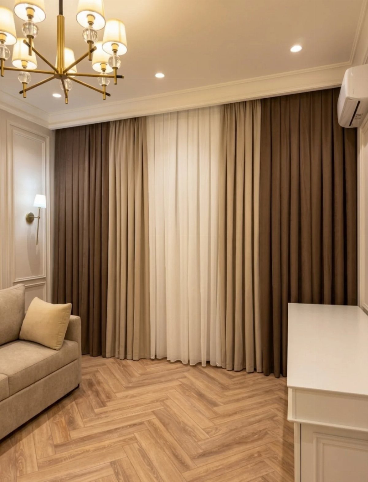 Floor-to-ceiling curtains in brown and white tones in a modern living room.