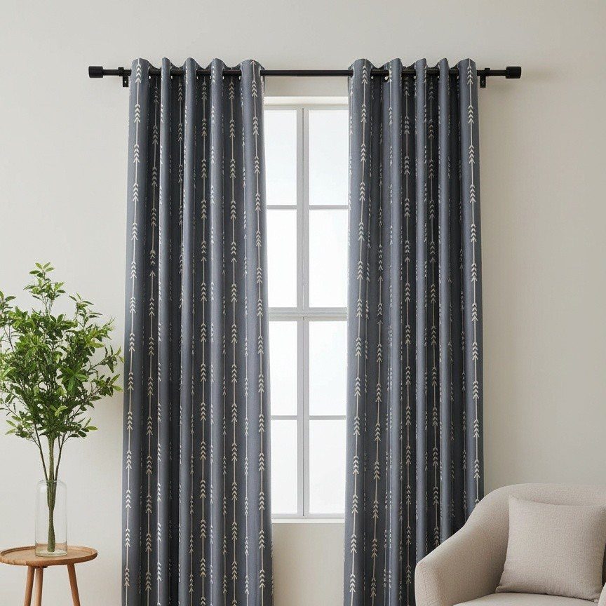 Dark grey patterned curtains hanging over a window in a bright living room