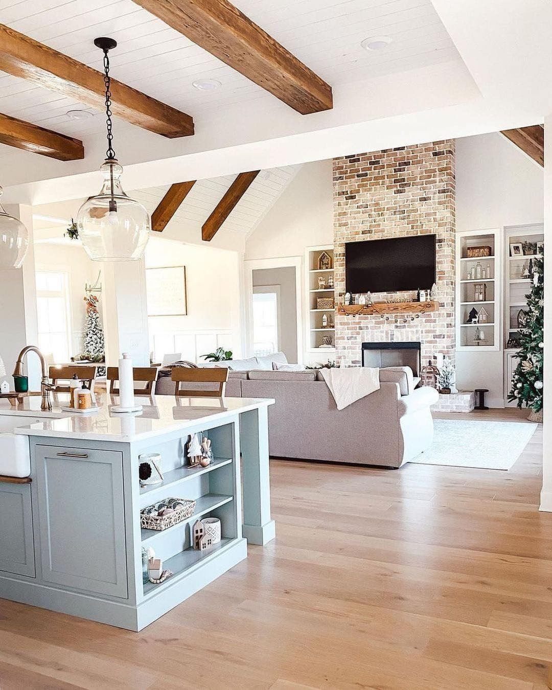 Light blue kitchen island with open shelving in a farmhouse living room.