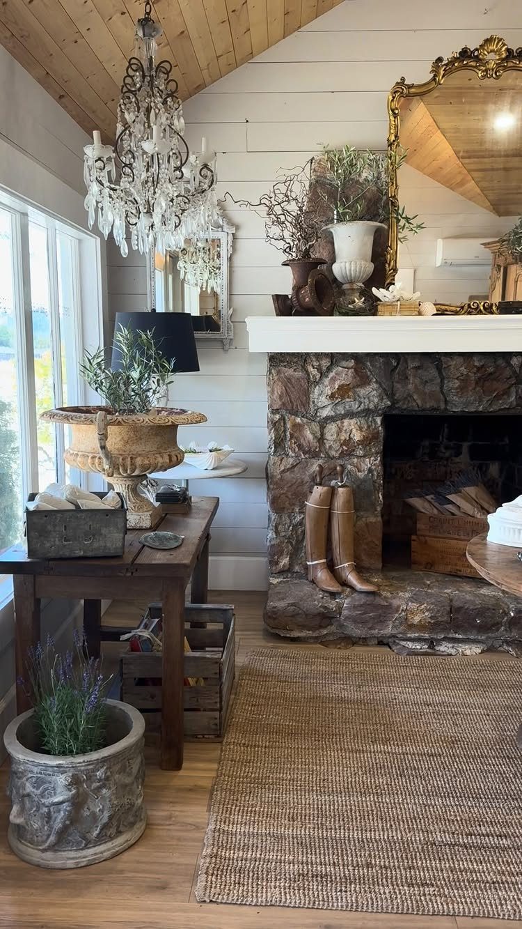 Rustic stone fireplace and crystal chandelier in a French country style living room