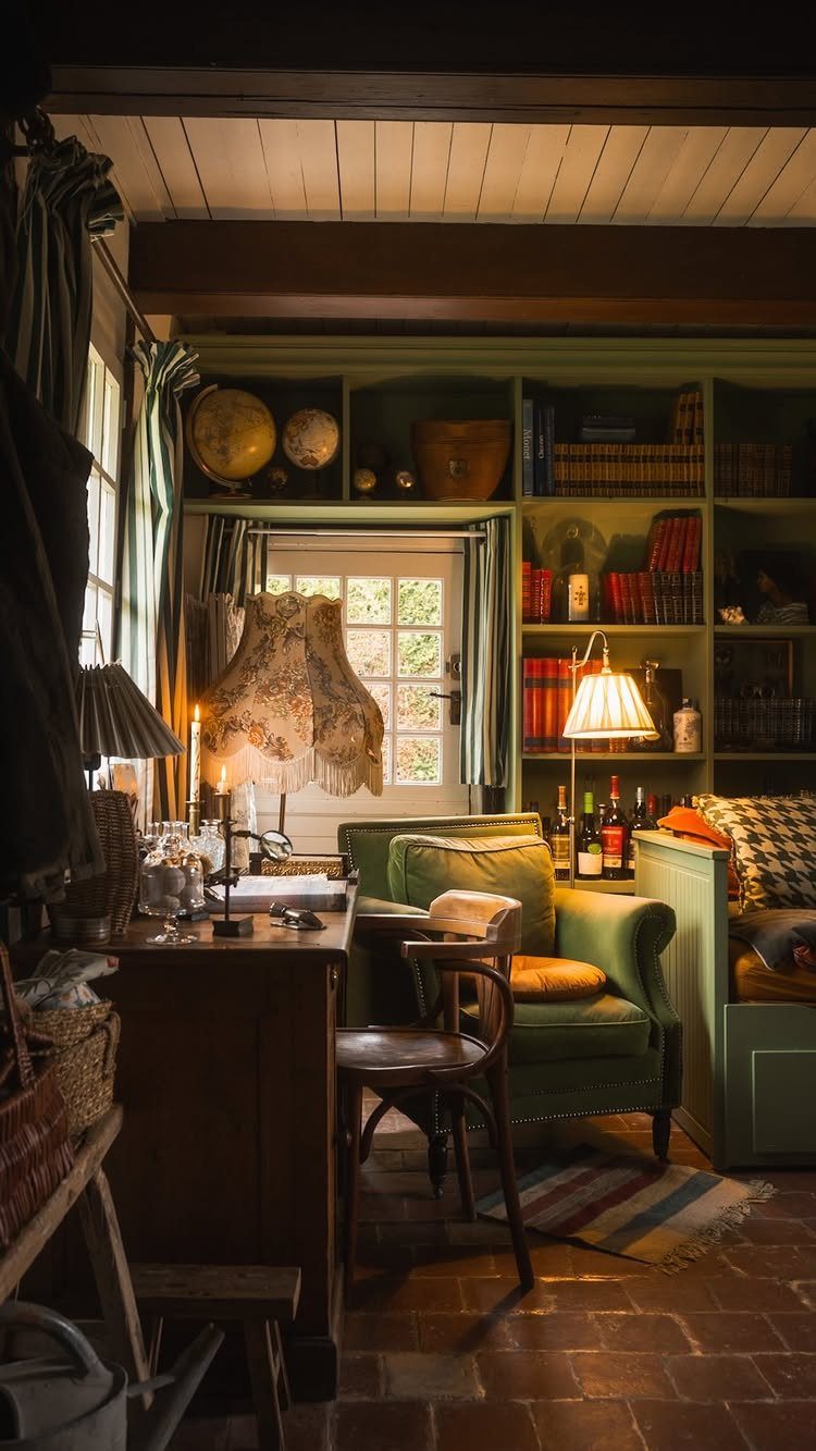 Cozy living room with green armchair, wooden desk, and built-in bookshelves on tile floors.