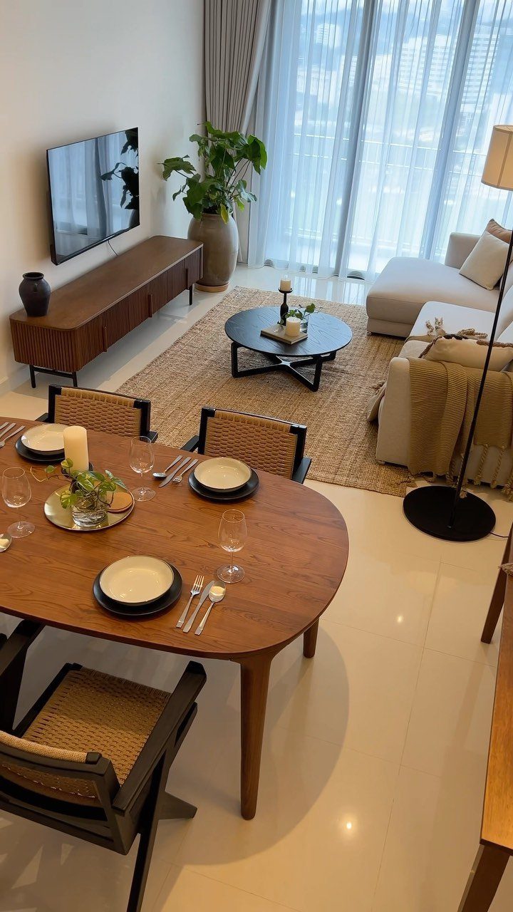 Modern small living and dining room with wooden furniture and neutral tones.