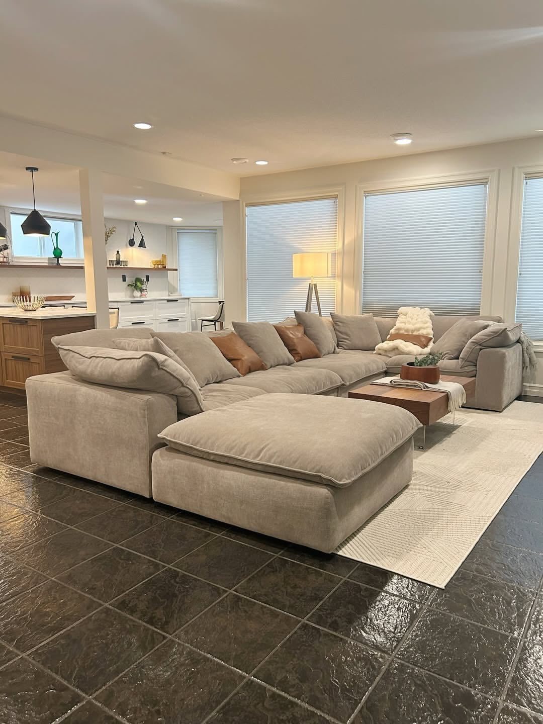 Light grey modular cloud sofa with brown pillows in a modern living room