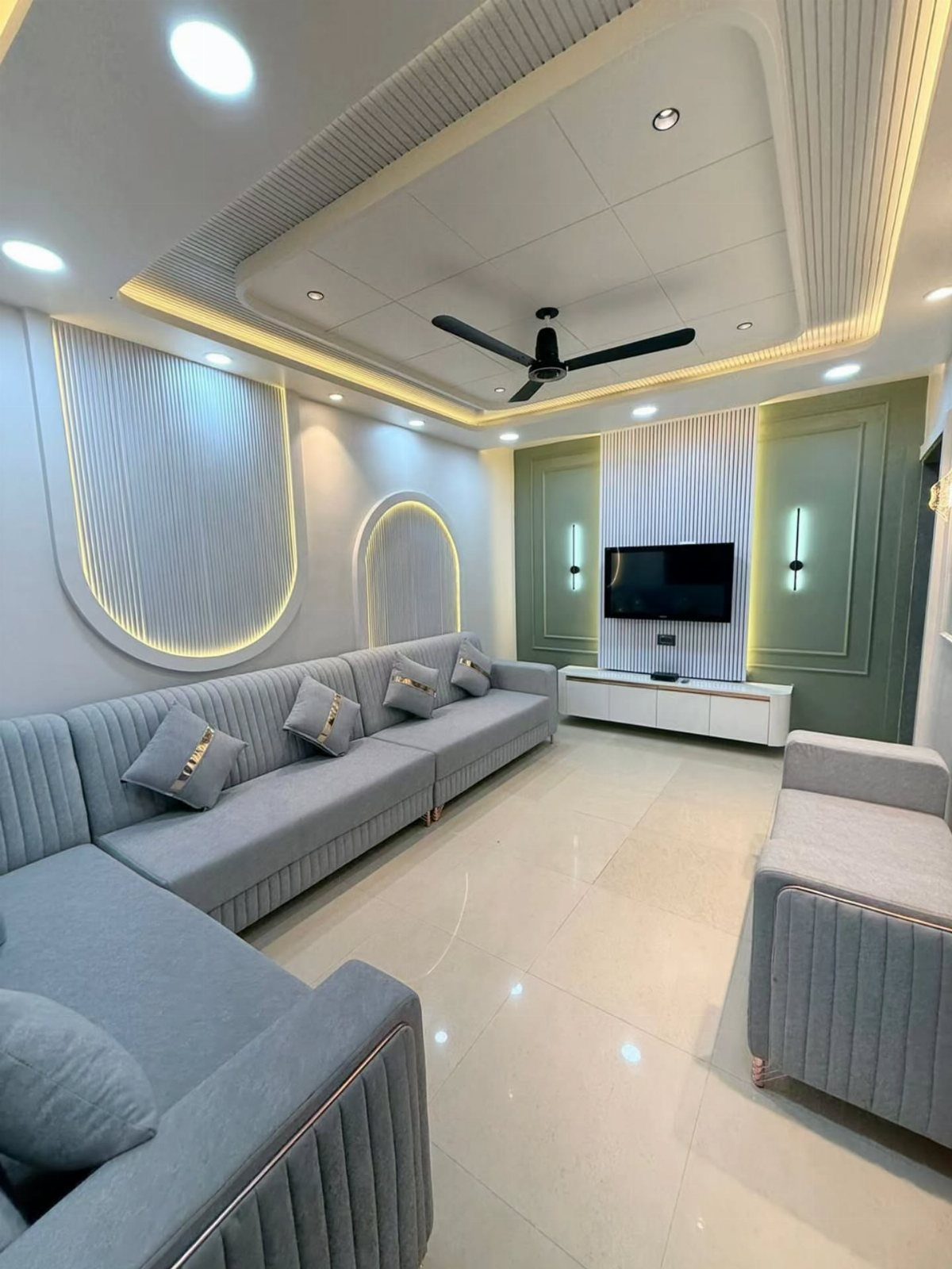 Light grey ribbed sofas in a bright room with white walls and LED lighting