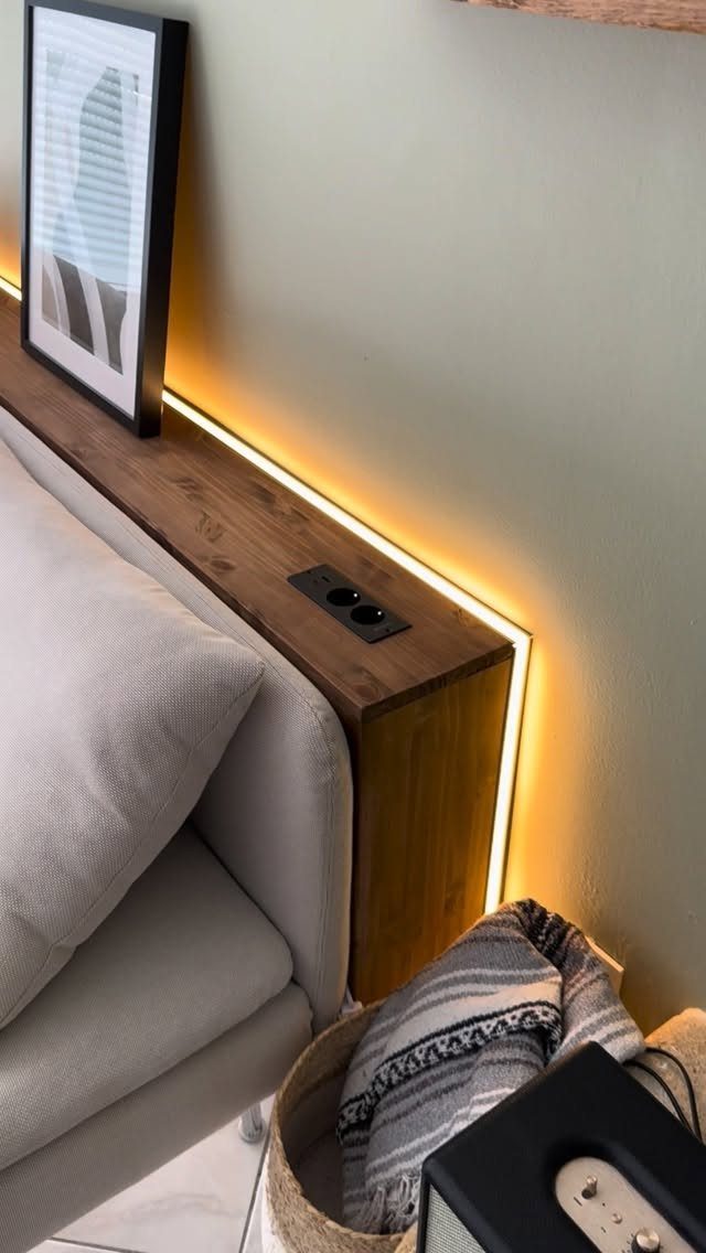 Wooden console table with LED lighting placed behind a light grey sofa
