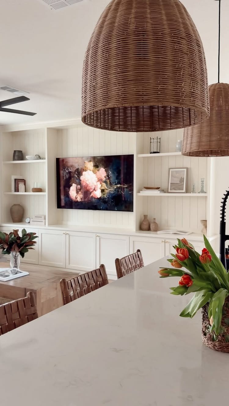 White built-in entertainment center with lower cabinets and open shelving in a living room.