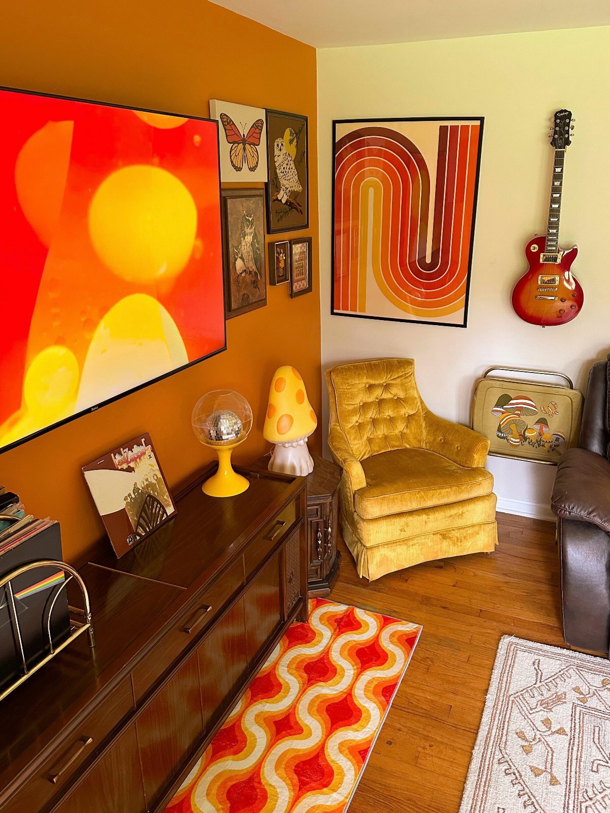Yellow velvet armchair and wavy orange rug in a retro 70s living room