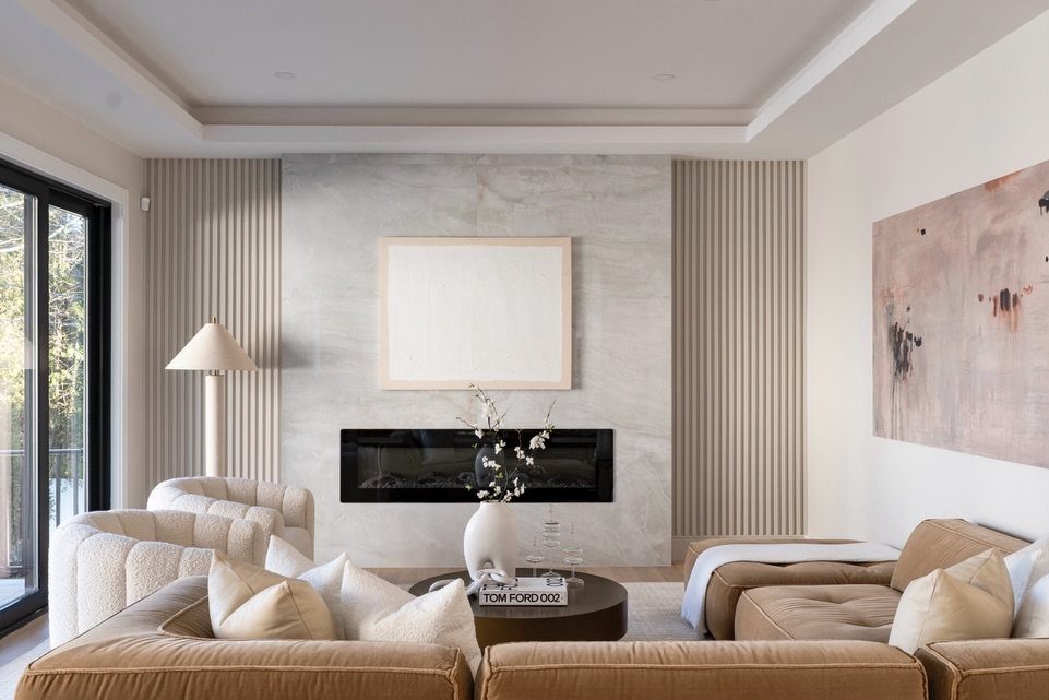 Brown sectional sofa in a modern living room with marble fireplace and wood slats