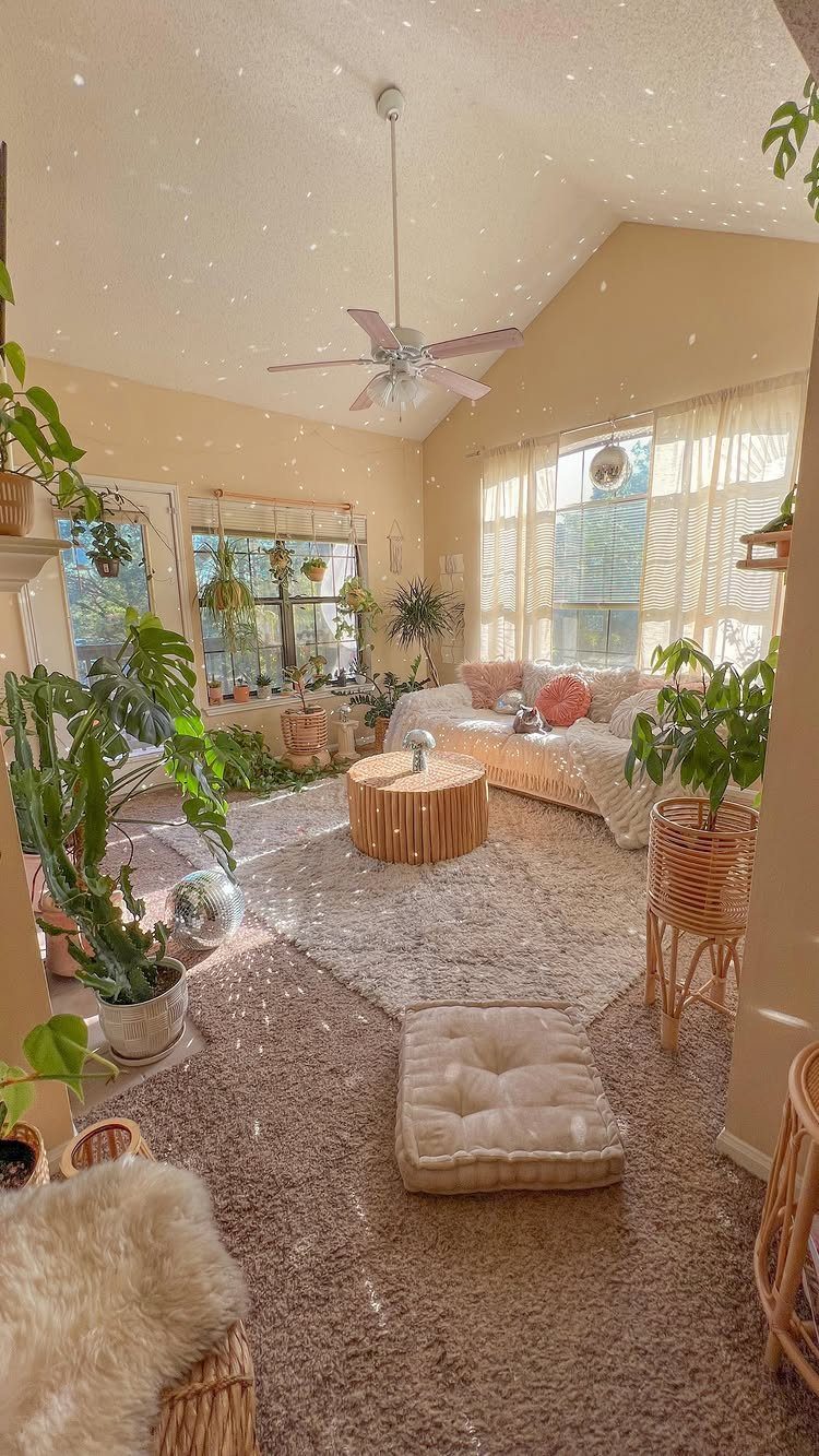 Bohemian living room with many green plants, a wooden table, and plush rugs.