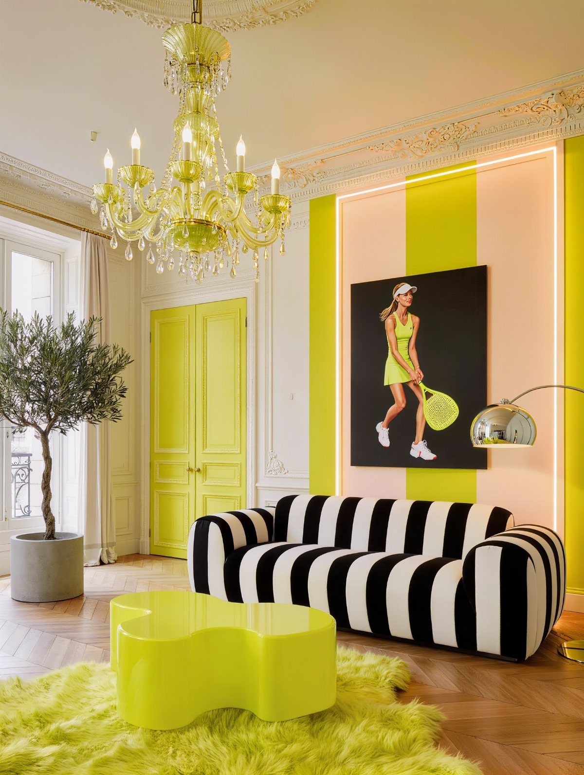 Black and white striped sofa in a room with lime green accents.