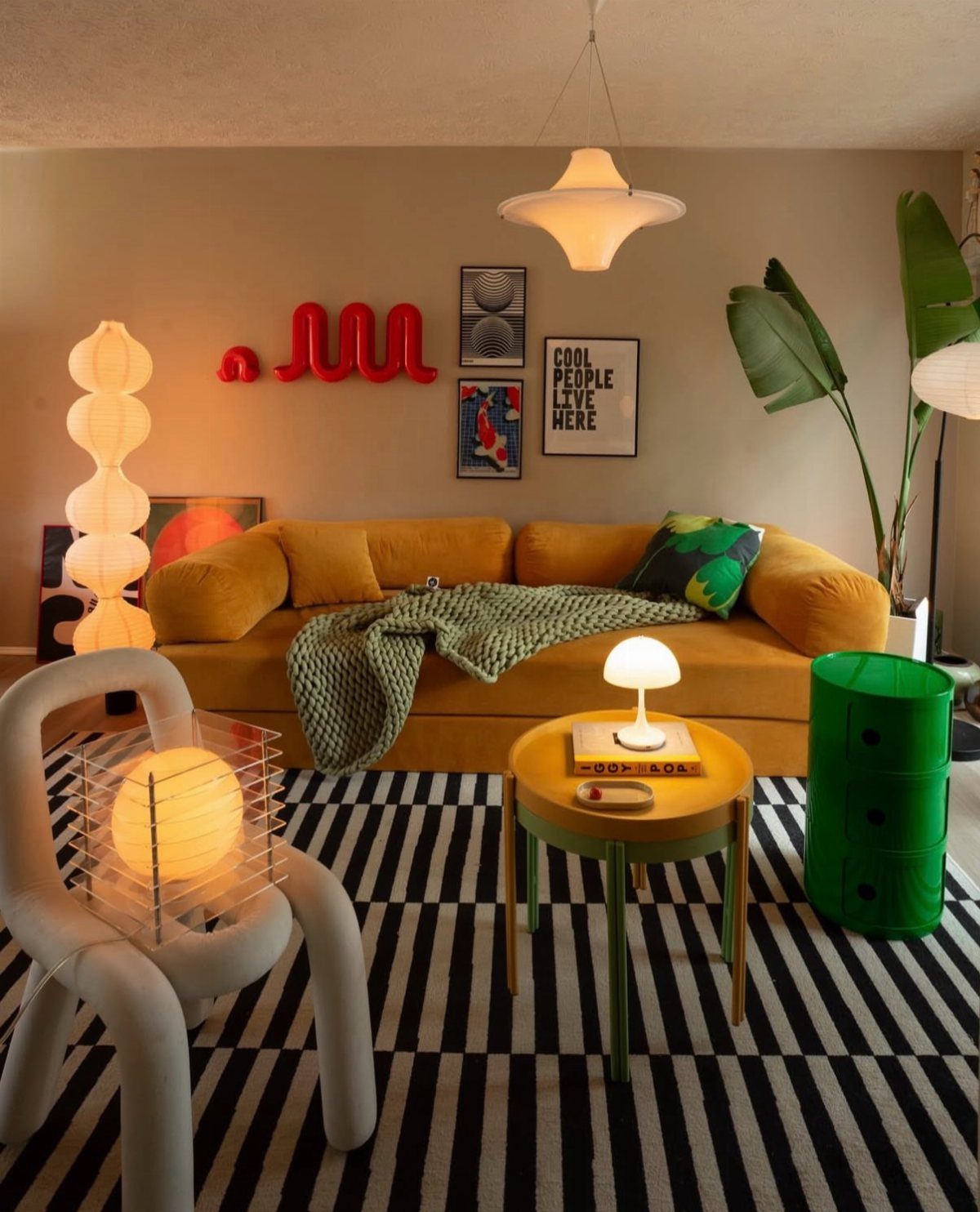 Mustard yellow sofa and curvy white chair in a colorful retro living room
