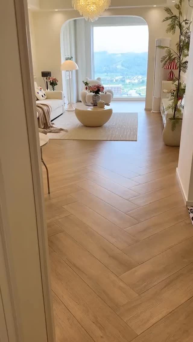 Light-colored wooden floors in a herringbone pattern in a bright modern living room.
