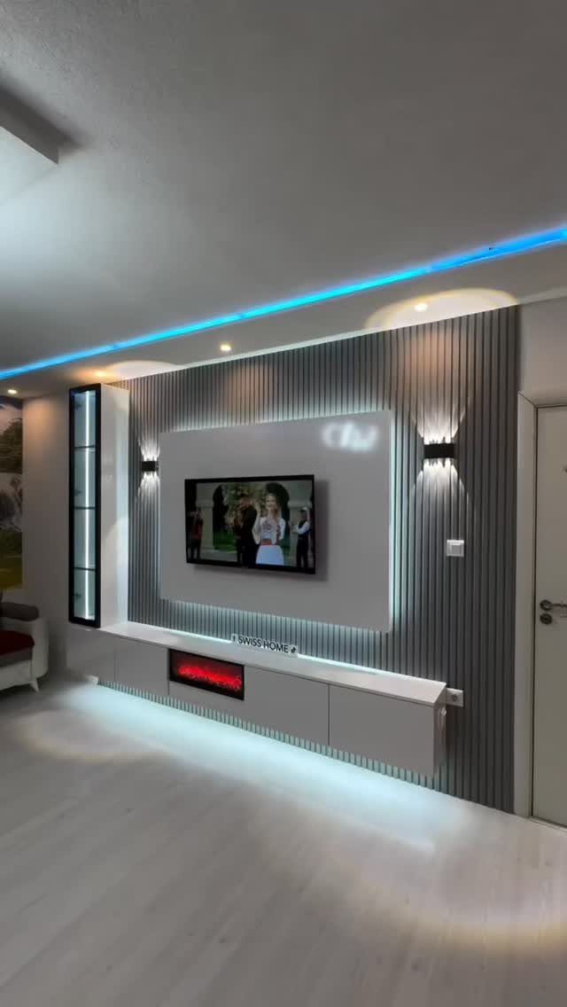 Modern living room with grey ribbed wall, floating console, and blue LED lighting.