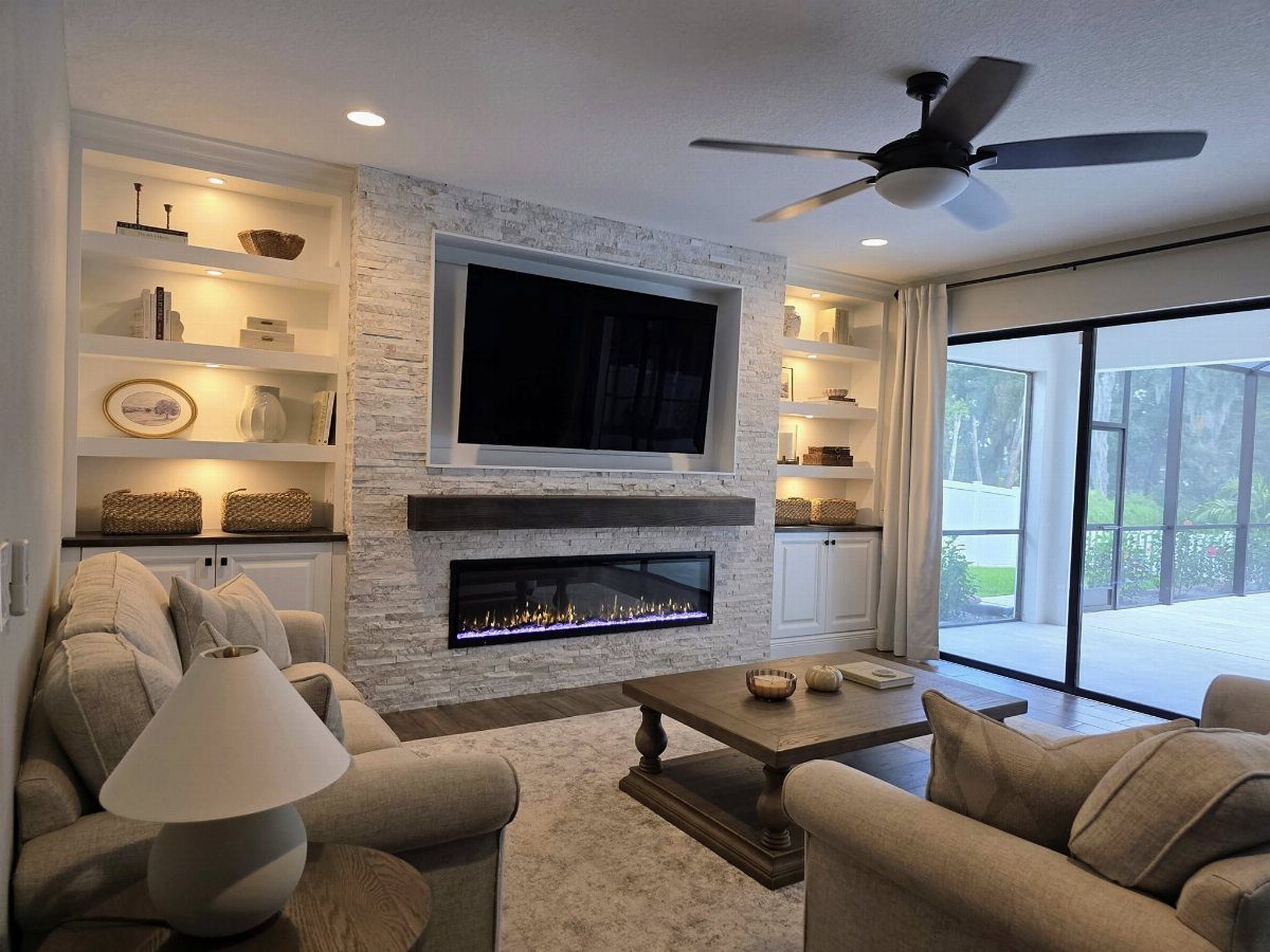 Centered linear fireplace with stone surround and symmetrical built-in shelving in modern living room