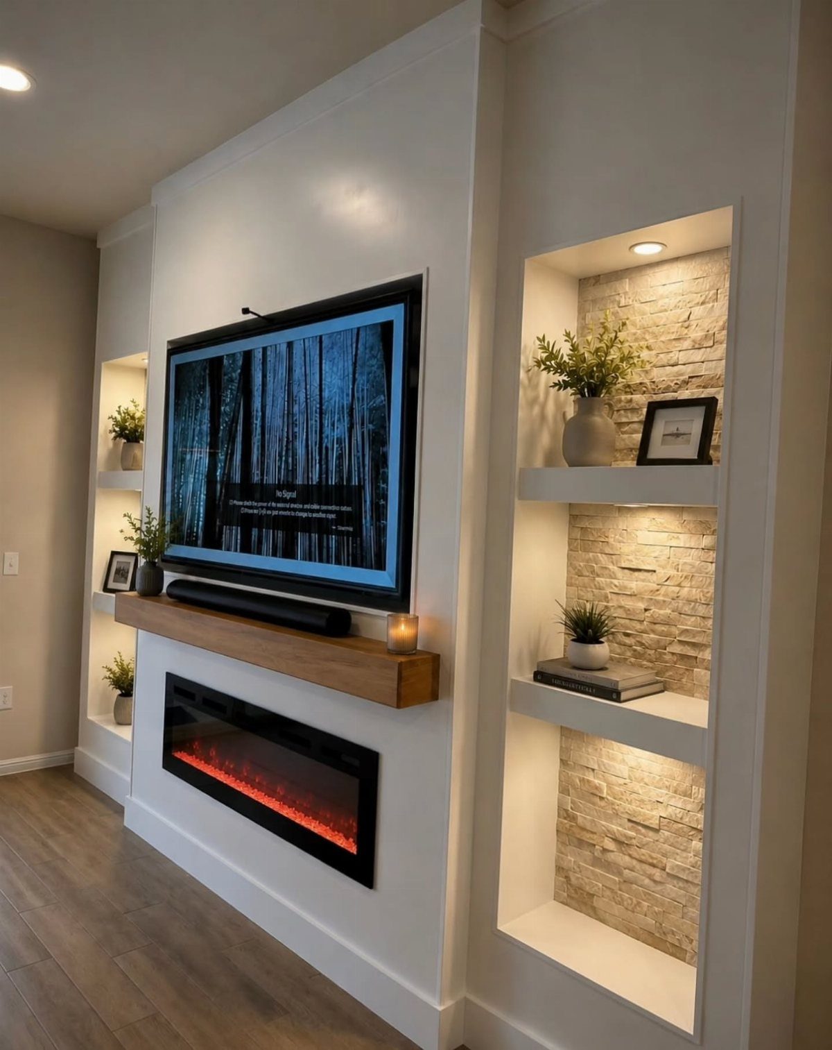 Modern white wall with electric fireplace, wooden mantel, and built-in stone-backed shelves.