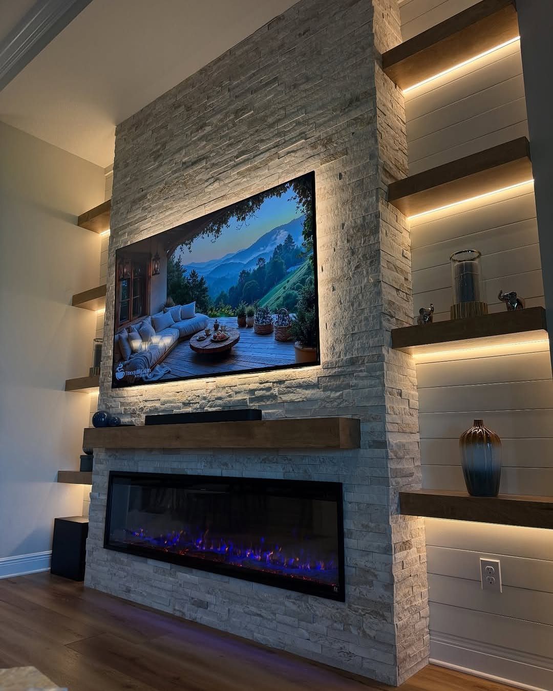 Stone fireplace wall with a mounted TV and integrated LED accent lighting.
