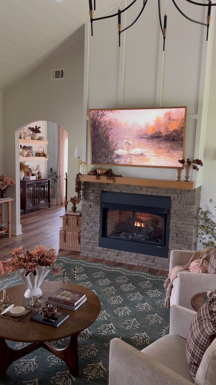 Dark green patterned rug in a cozy living room with a stone fireplace.