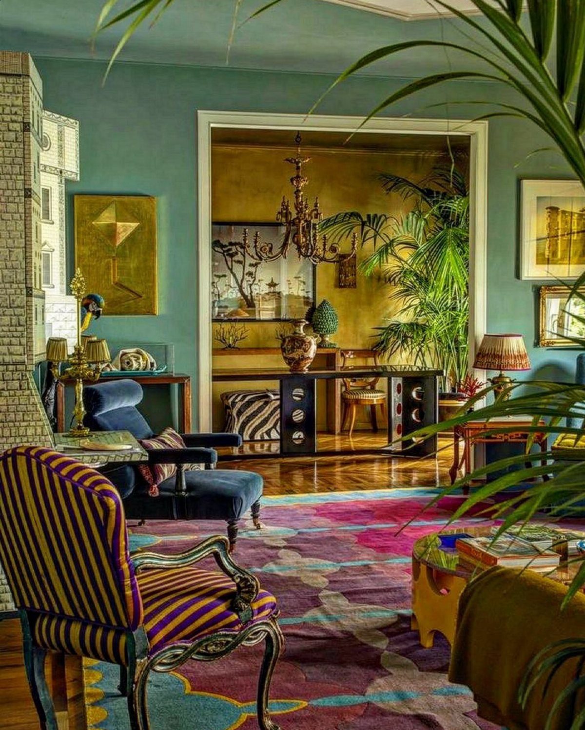 Striped yellow and purple armchair in an eclectic living room with teal walls.