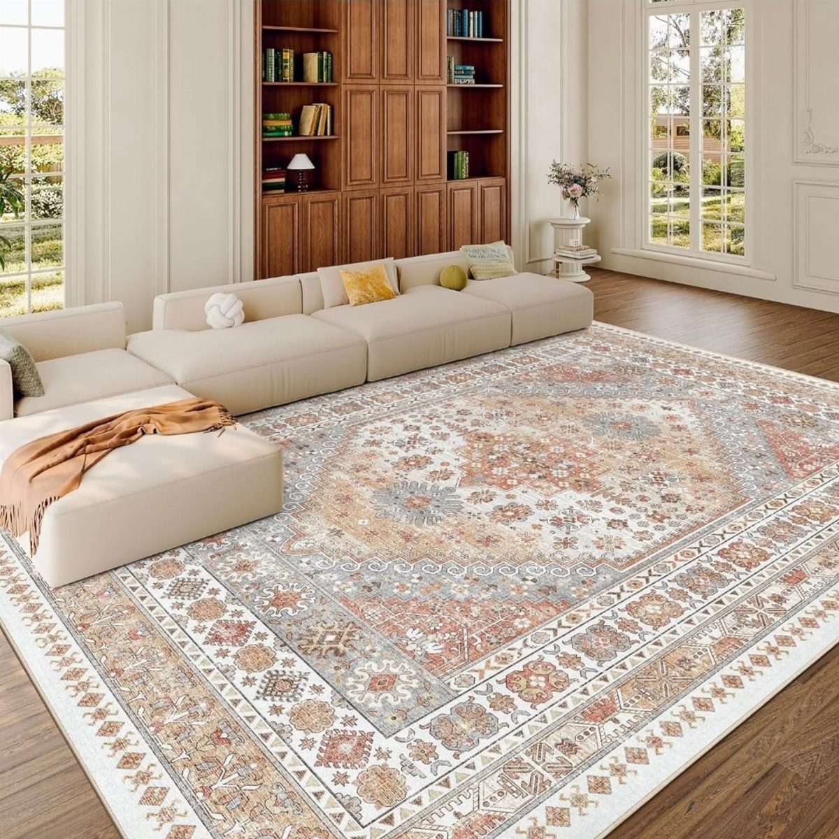 Rectangular patterned rug under a cream modular sofa in a bright living room