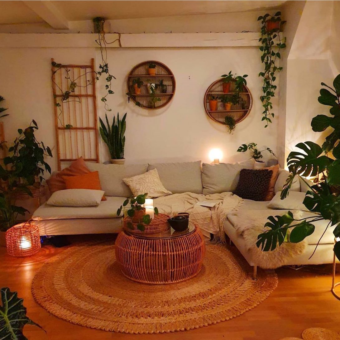 Round jute rug under a woven coffee table in a plant-filled living room