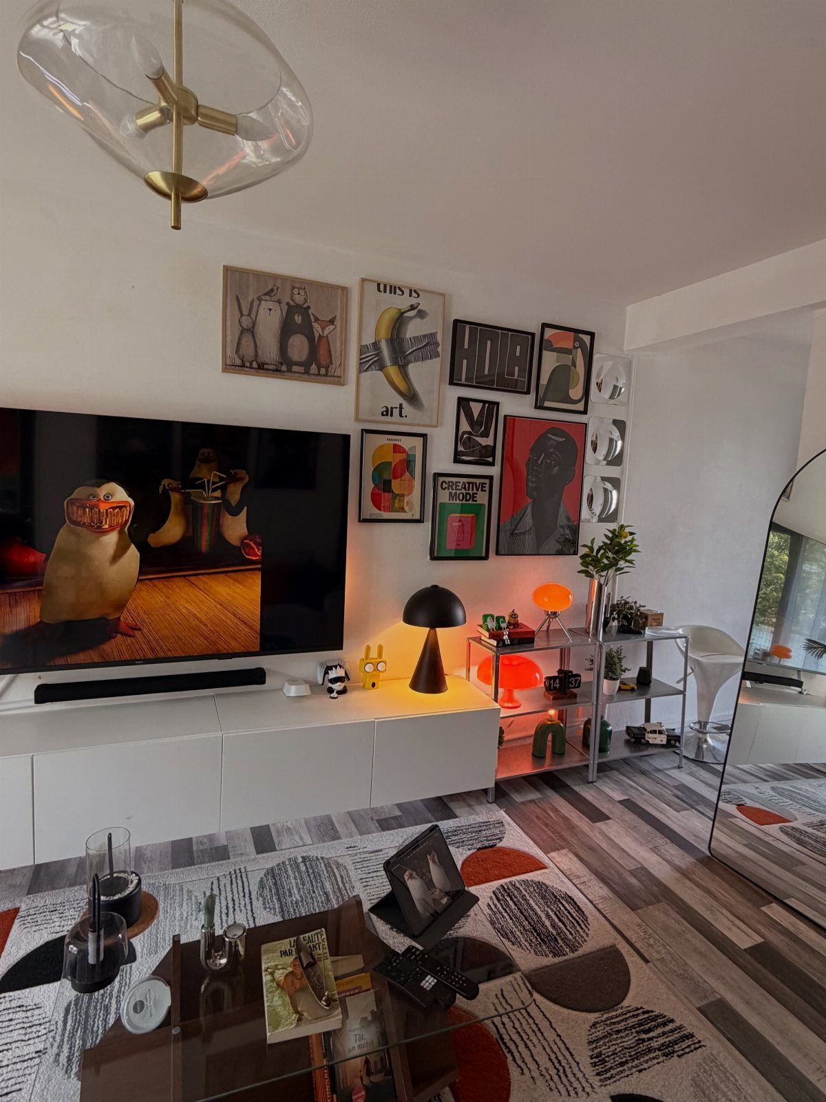 Modern living room with a geometric patterned rug and a gallery wall of art.