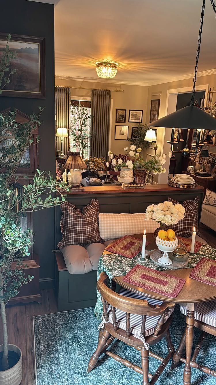 Dining nook with mixed plaid pillows, patterned tablecloth, and a blue patterned rug.