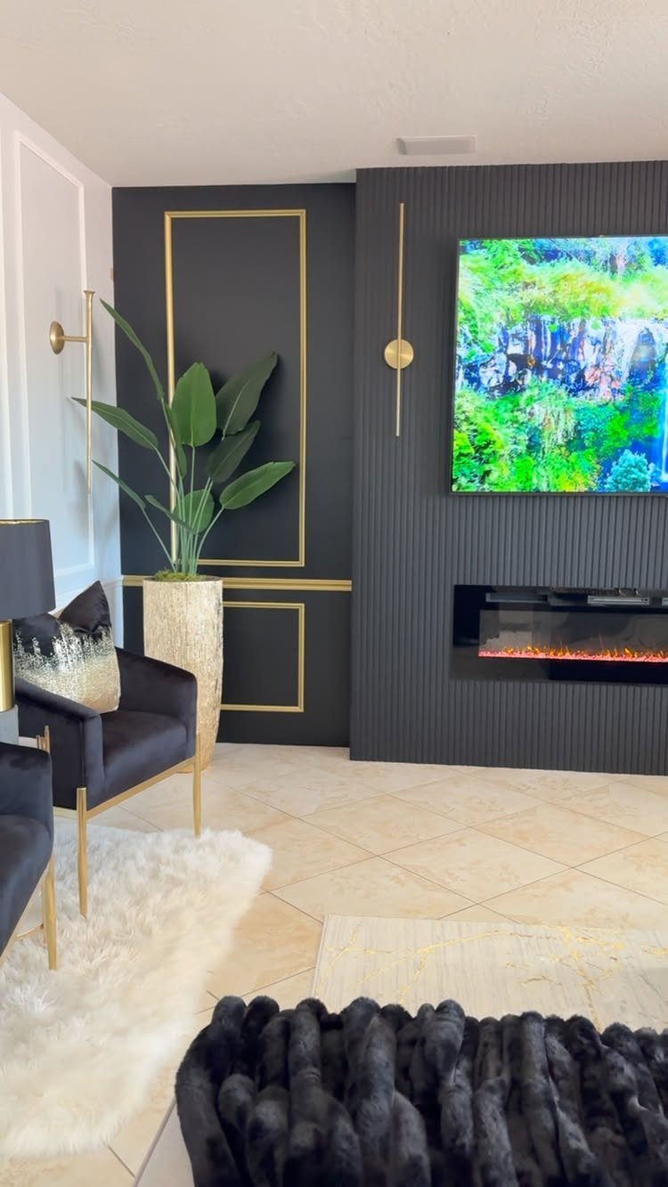 Modern living room with black walls, gold accents, and a sleek black fireplace.