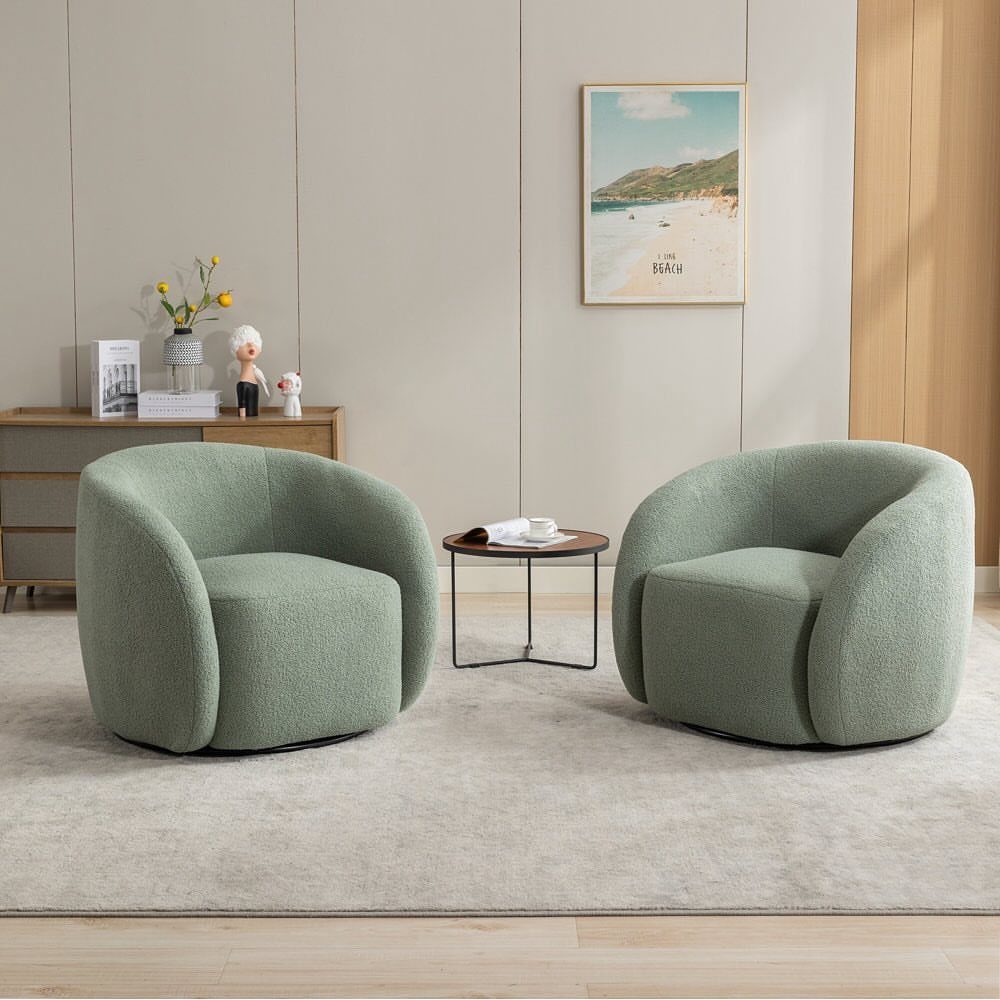 Two light green rounded armchairs with a small round table in a minimalist room