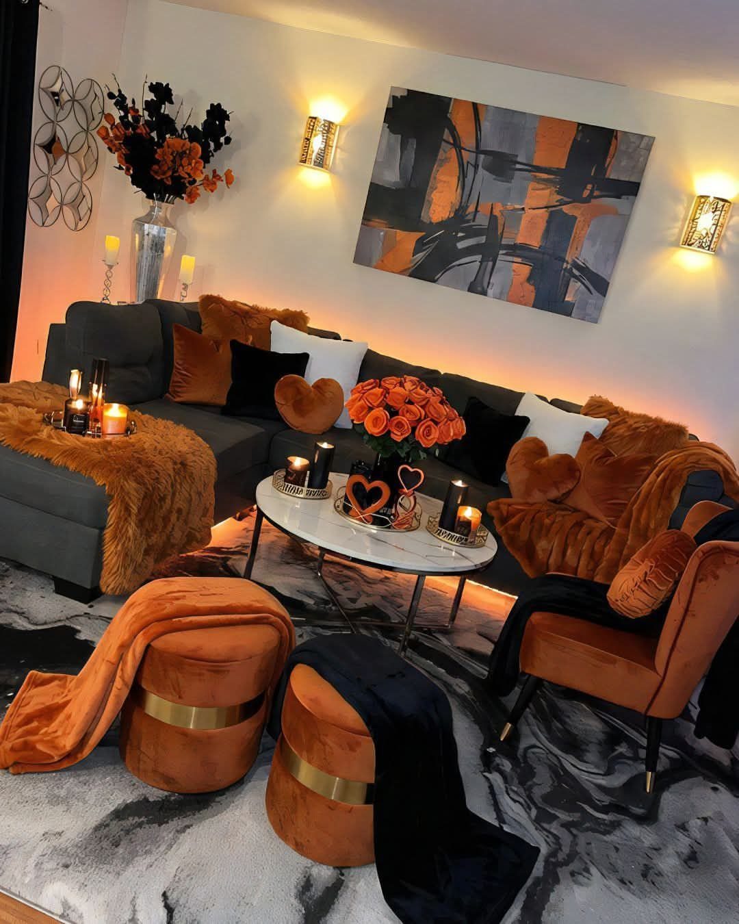 Dark grey sectional sofa with orange velvet accents and abstract orange wall art.