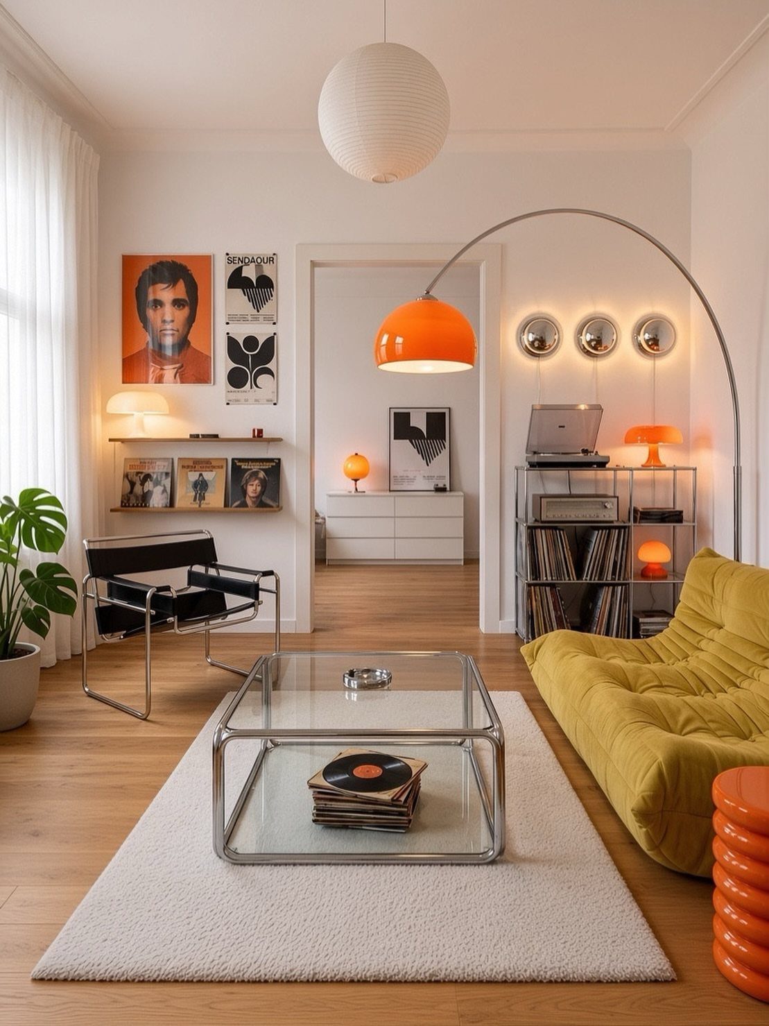 Yellow tufted sofa and black leather chair with slim chrome legs in living room