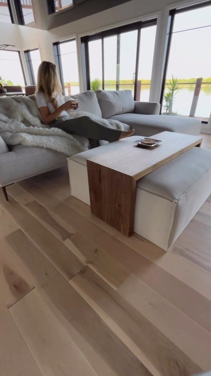 White upholstered ottoman used as a coffee table base in a modern living room.