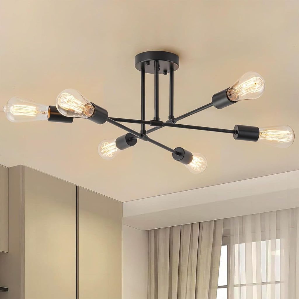 Modern black metal ceiling fixture with six glowing Edison bulbs in a neutral room.