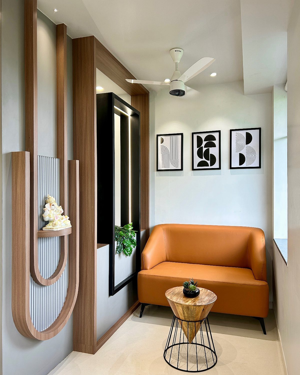 Orange leather couch in a modern office with wooden wall panels and art.