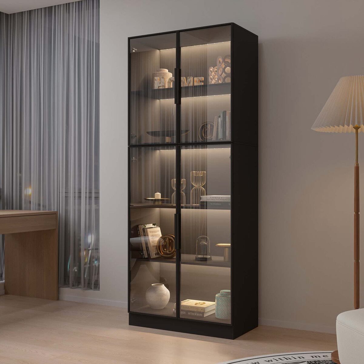 Black glass-door display cabinet with shelves containing books and vases in a room.