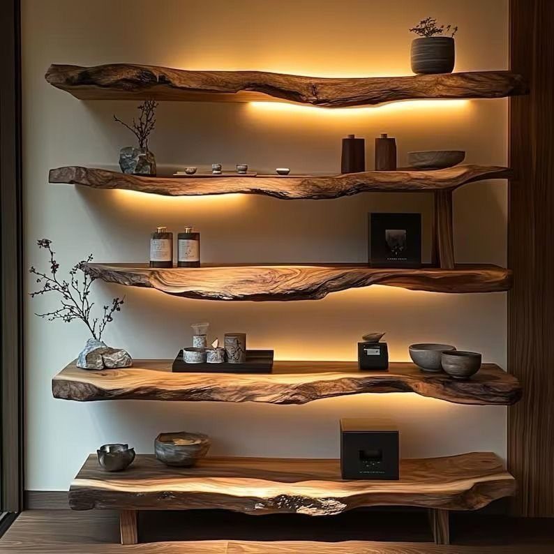 Live-edge wooden shelves with warm under-lighting holding minimalist ceramic decor on a wall