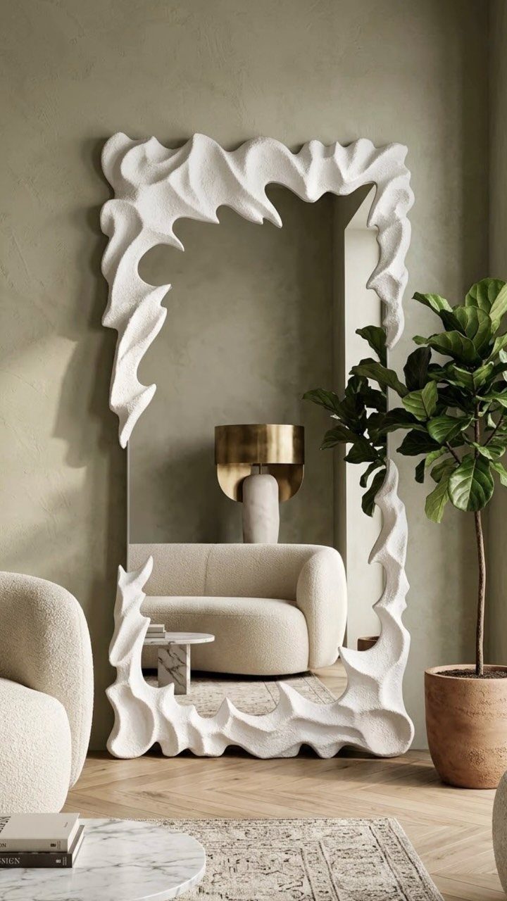 Large floor mirror with a white sculptural frame in a modern organic living room